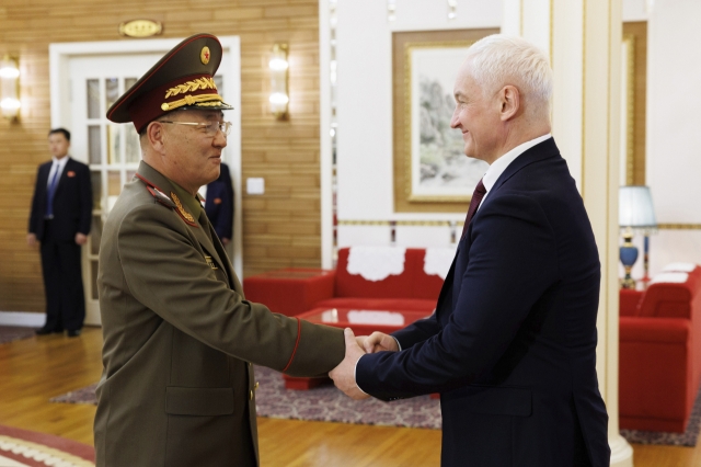 In this photo released by the Russian Defense Ministry press service, North Korean Defense Minister No Kwang Chol (left) and Russian Defense Minister Andrei Belousov, right, shake hands during their meeting in Pyongyang, North Korea, Friday. (Russian Defense Ministry Press Service via AP)